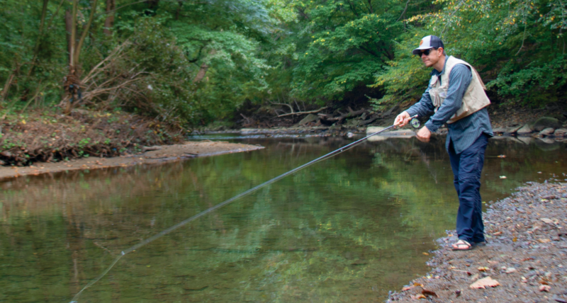 An angler fishes in Philadelphia's Pennypack Creek.