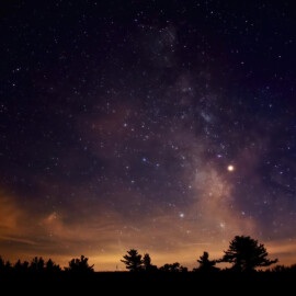 Night sky just at sunset with many stars shining bright in the sky.