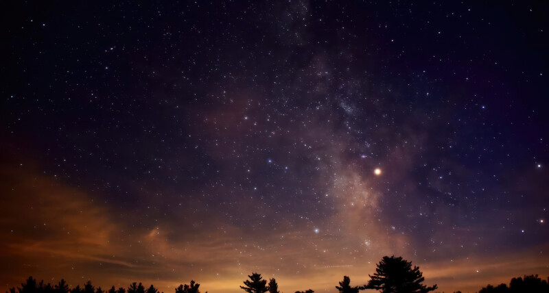 Night sky just at sunset with many stars shining bright in the sky.
